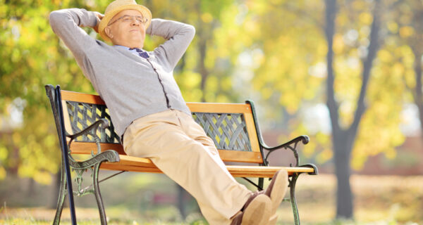 Senior,Gentleman,Sitting,On,A,Wooden,Bench,And,Relaxing,In