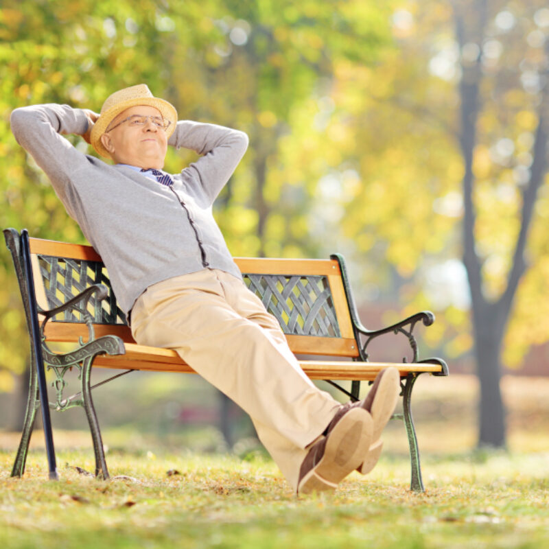Senior,Gentleman,Sitting,On,A,Wooden,Bench,And,Relaxing,In
